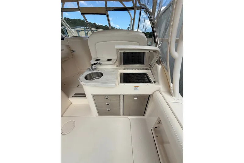 Slide: The Image of 2017 Grady-White Freedom 335 boat interior with sink and grill station. - 12