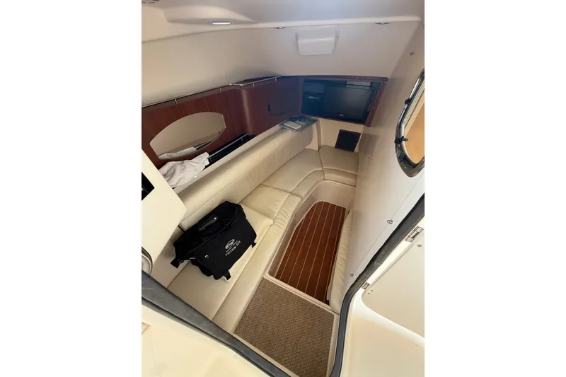 Slide: The Image of 2017 Grady-White Freedom 335 cabin interior with seating and wood accents. - 7