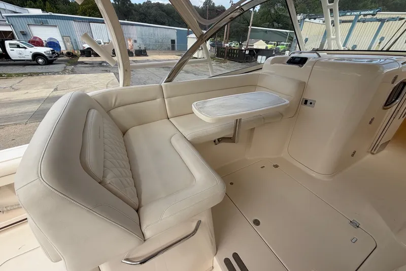Slide: The Image of 2017 Grady-White Freedom 335 boat interior with beige seating and table. - 13