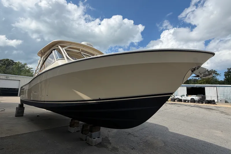 Slide: The Image of 2017 Grady-White Freedom 335 boat on blocks, under a partly cloudy sky. - 3