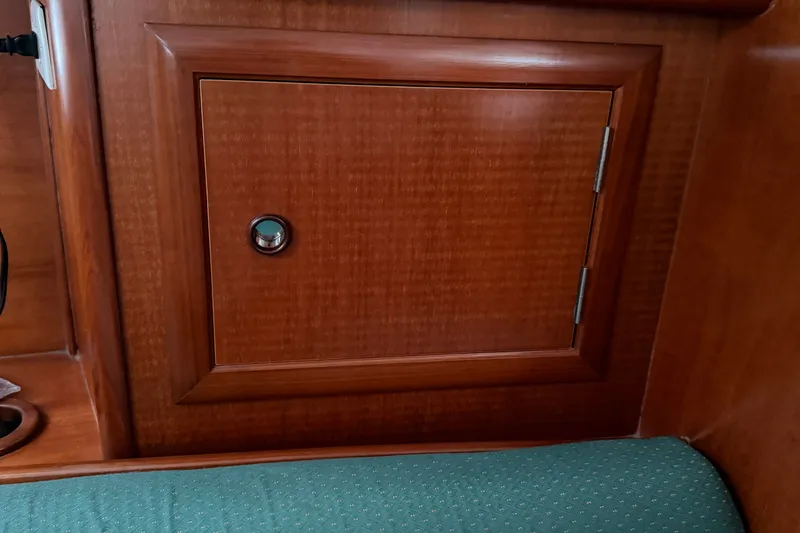 Slide: The Image of Wooden cabinet door inside a 2001 Beneteau 331 sailboat interior. - 14