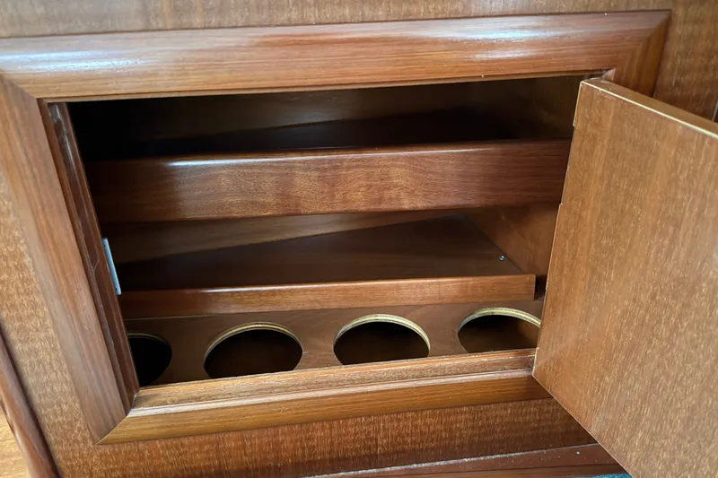 Slide: The Image of Wooden storage cabinet with circular cutouts inside a 2001 Beneteau 331 sailboat. - 15