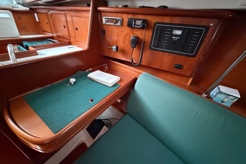 Slide: The Image of Interior of 2001 Beneteau 331 sailboat with navigation station and control panel. - 13