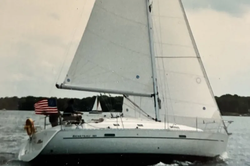 Slide: The Image of Sailing yacht Beneteau 331, 2001 model, cruising on open water with American flag. - 0