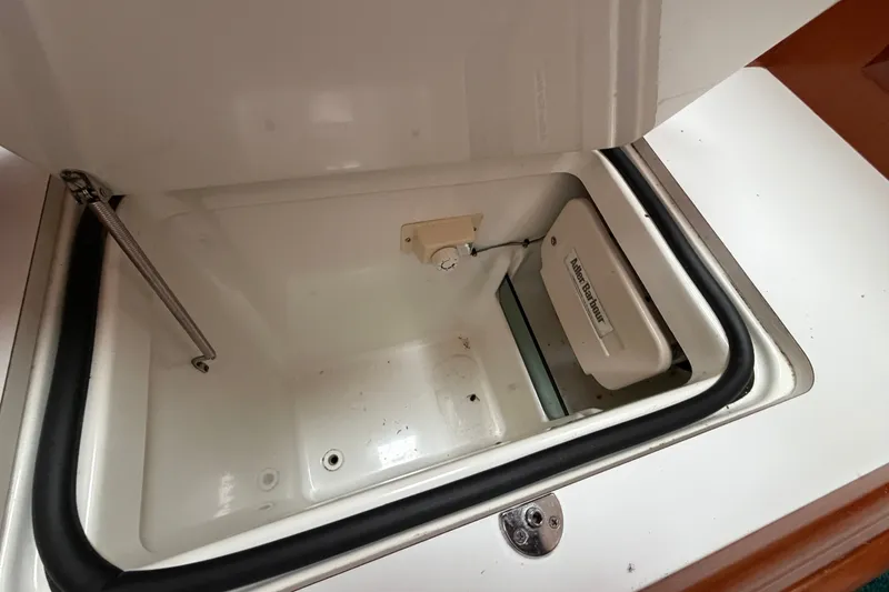 Slide: The Image of Open storage compartment on a 2001 Beneteau 331 sailboat, featuring a spring hinge. - 22