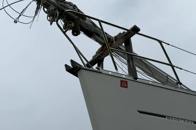 Slide: The Image of Bow of a 2001 Beneteau 331 sailboat with rigging against a cloudy sky. - 4