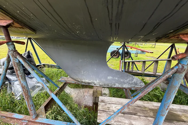 Slide: The Image of 2001 Beneteau 331 sailboat keel on stands, showcasing hull structure and support. - 5