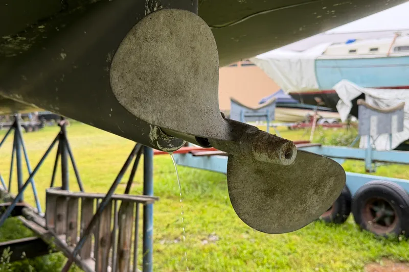 Slide: The Image of Propeller of a 2001 Beneteau 331 sailboat on a trailer in a yard. - 7