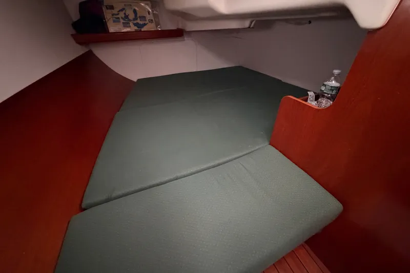 Slide: The Image of Interior cabin of a 2001 Beneteau 331 sailboat with green cushions. - 29