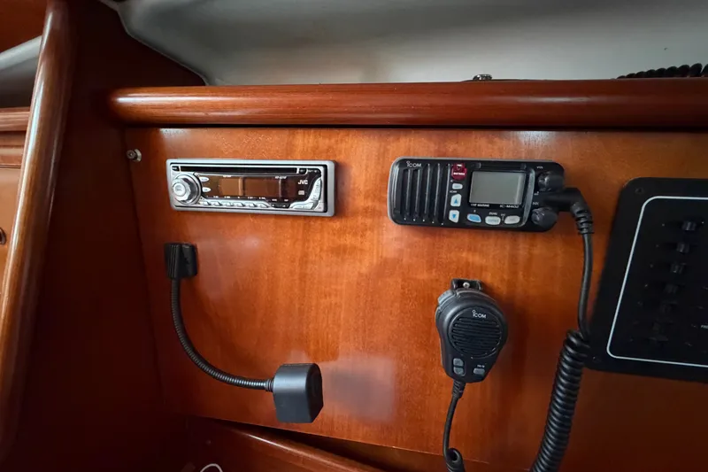 Slide: The Image of Control panel of a 2001 Beneteau 331 sailboat with radio and communication equipment. - 18