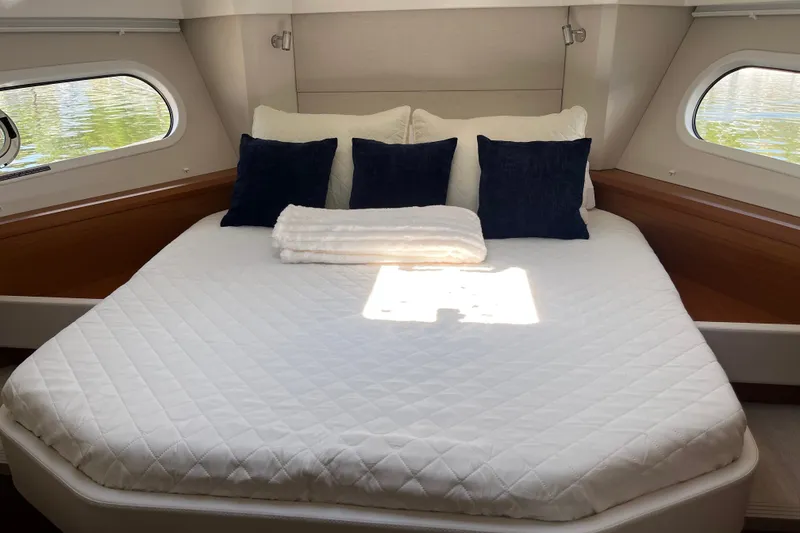 Slide: The Image of Luxurious bedroom in 2026 Beneteau Swift Trawler 41 Fly with plush bedding and elegant decor. - 28