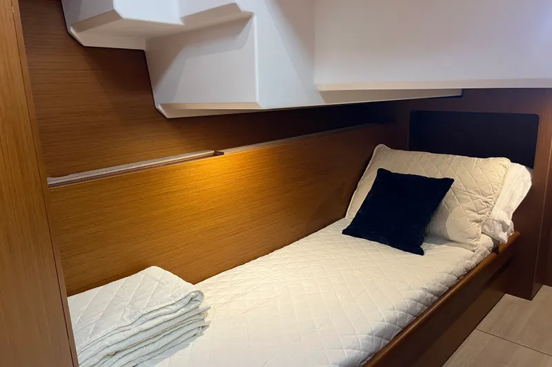 Slide: The Image of Cozy cabin bed in 2026 Beneteau Swift Trawler 41 Fly, featuring elegant wood paneling. - 25