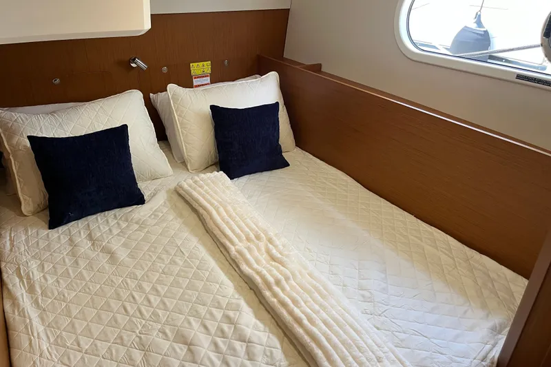 Slide: The Image of Luxurious cabin interior of 2026 Beneteau Swift Trawler 41 Fly with cozy bedding. - 24