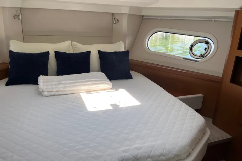 Slide: The Image of Luxurious bedroom interior of 2026 Beneteau Swift Trawler 41 Fly with cozy bedding. - 27