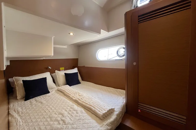 Slide: The Image of Luxurious cabin interior of 2026 Beneteau Swift Trawler 41 Fly with cozy bedding. - 23