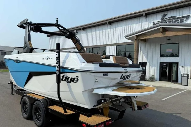 Slide: The Image of 2027 Tigé Z3 boat on trailer outside dealership, showcasing sleek design and modern features. - 10