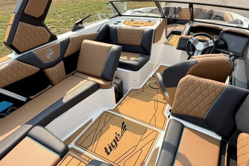 Slide: The Image of Luxurious interior of 2027 Tigé Z3 boat with tan and black seating. - 7