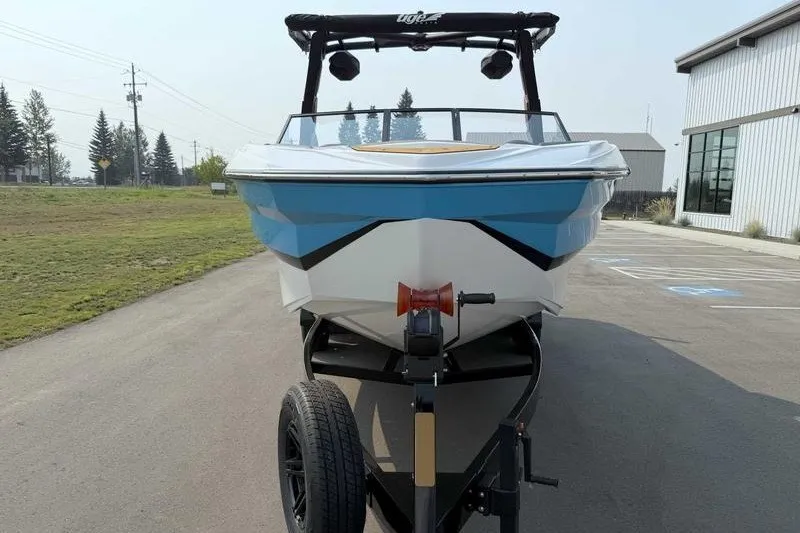 Slide: The Image of 2027 Tigé Z3 boat on trailer, parked outdoors near a building. - 14