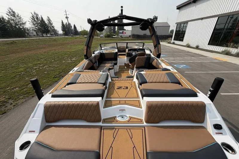 Slide: The Image of 2027 Tigé Z3 boat with luxurious seating and modern design in a parking area. - 12