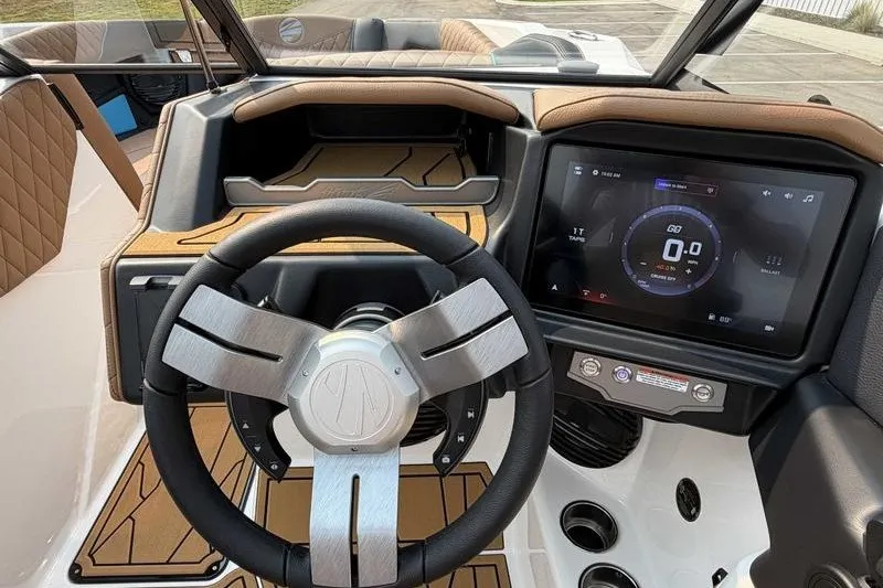 Slide: The Image of 2027 Tigé Z3 boat dashboard with modern steering wheel and touchscreen display. - 17
