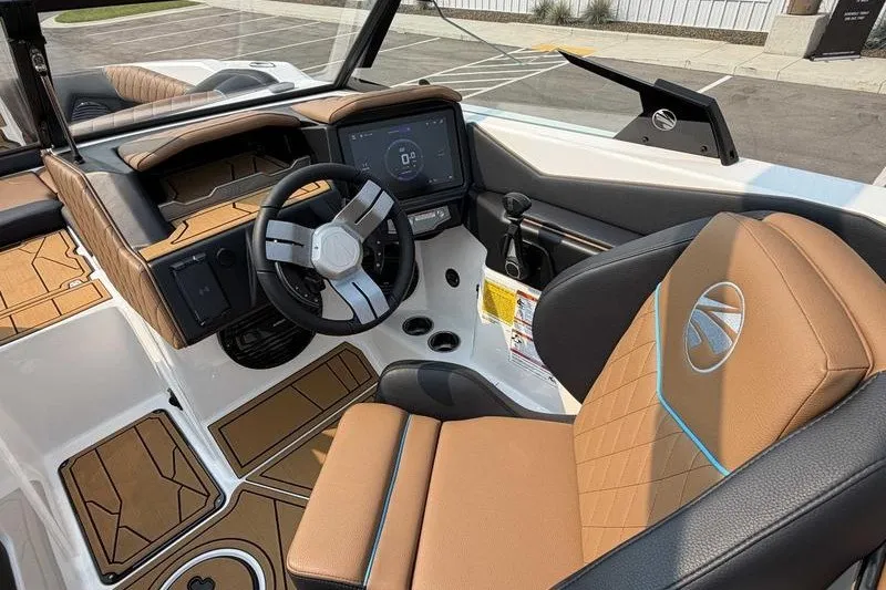 Slide: The Image of 2027 Tigé Z3 boat interior with modern dashboard and tan leather seating. - 18