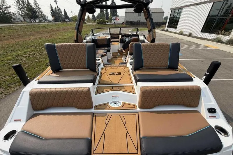 Slide: The Image of 2027 Tigé Z3 boat interior with luxurious seating and modern design in a parking area. - 8