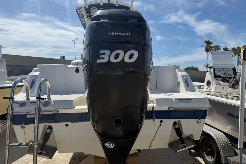 Slide: The Image of 2018 Wellcraft 242 Fisherman boat with powerful Verado 300 engine, docked under clear skies. - 3