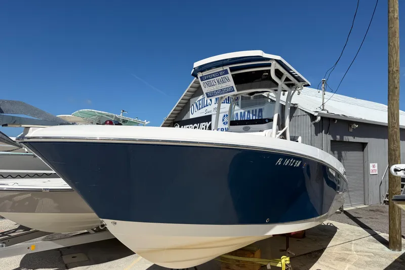 The Image of 2018 Wellcraft 242 Fisherman boat displayed outdoors at a marina. - 1