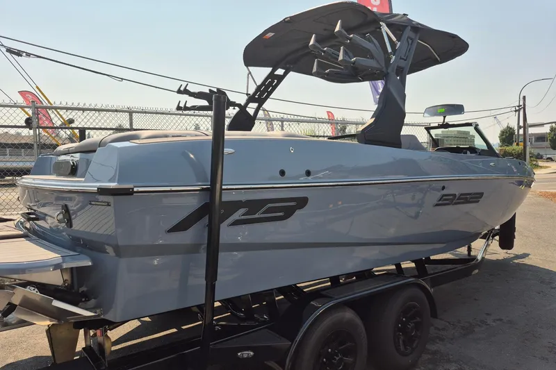 Slide: The Image of 2027 MB B52-23 Classic LIMITED boat on trailer, sleek design, outdoor display. - 2