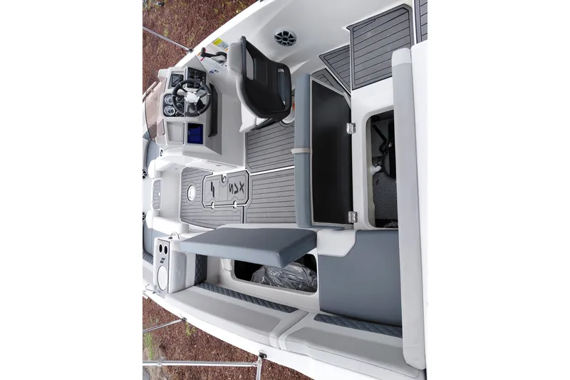 Slide: The Image of 2027 Starcraft SVX 211 OB boat interior with modern seating and steering console. - 21