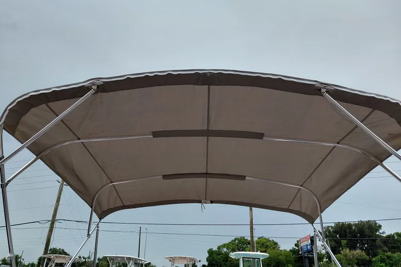 Slide: The Image of Bimini top of 2027 Starcraft SVX 211 OB boat against a cloudy sky. - 27