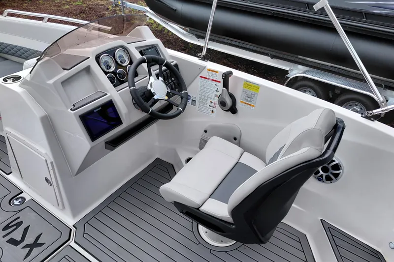 Slide: The Image of 2027 Starcraft SVX 211 OB boat cockpit with modern steering and comfortable seating. - 15