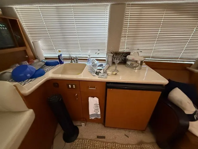 Slide: The Image of Interior of a 1997 Ocean Yachts 40ss with a sink, fridge, and countertop. - 11