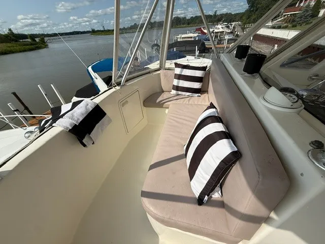 Slide: The Image of The image shows the deck of a 1997 Ocean Yachts 40ss with striped cushions. - 7