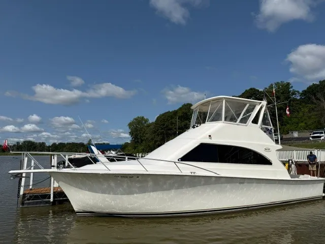 Slide: The Image of A white Ocean Yachts 40ss from 1997 is docked, featuring a flybridge and sleek design. - 2