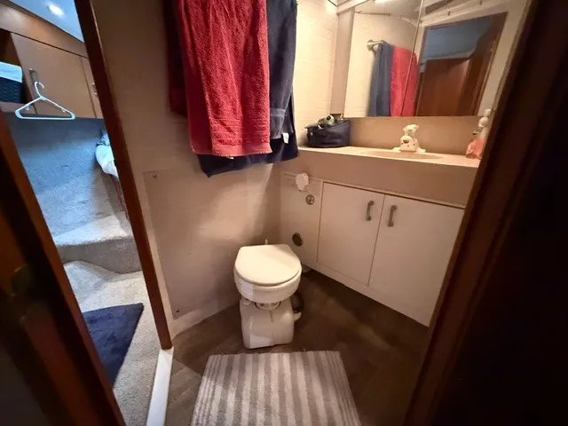 Slide: The Image of Bathroom in a 1997 Ocean Yachts 40ss with toilet, sink, and towels. - 15