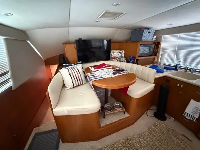 Slide: The Image of Interior of a 1997 Ocean Yachts 40ss with a cozy seating area and table. - 10