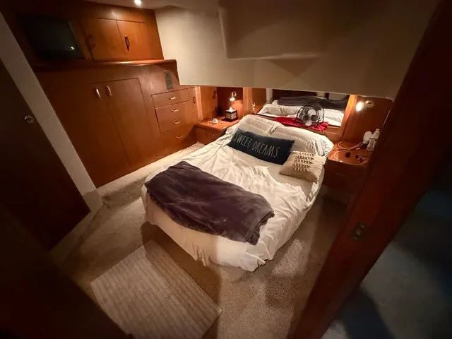 Slide: The Image of The image shows a cozy cabin with a double bed, wooden furniture, and soft lighting. - 14