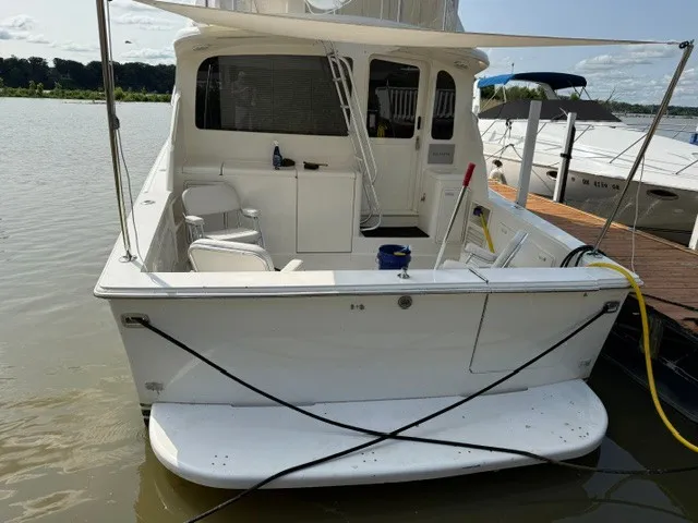 Slide: The Image of Rear view of a 1997 Ocean Yachts 40ss docked on a calm river. - 4