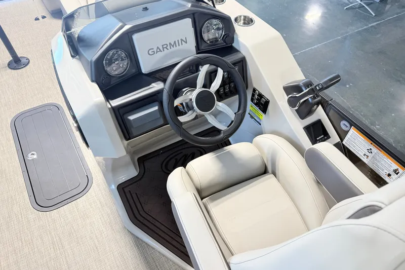Slide: The Image of 2027 Manitou Encore SL 25 boat cockpit with Garmin navigation system and luxurious seating. - 14