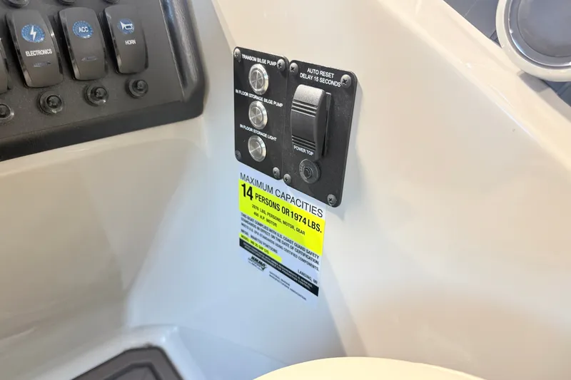 Slide: The Image of Control panel of 2027 Manitou Encore SL 25 boat, showing capacity for 14 people. - 15