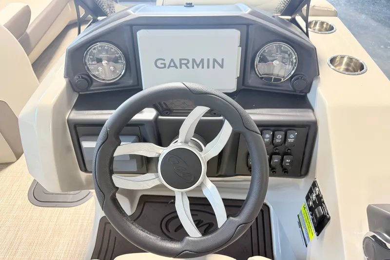 Slide: The Image of 2027 Manitou Encore SL 25 dashboard with Garmin display and steering wheel. - 16