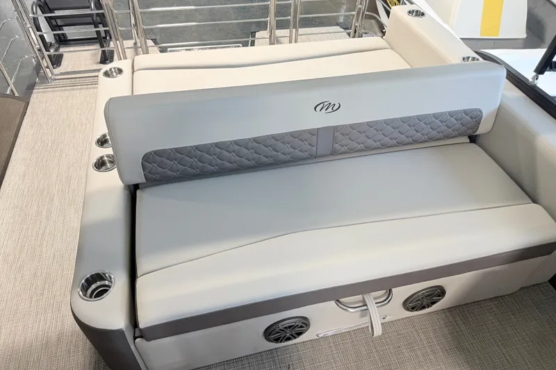 Slide: The Image of 2027 Manitou Encore SL 25 boat interior with luxurious seating and cup holders. - 17