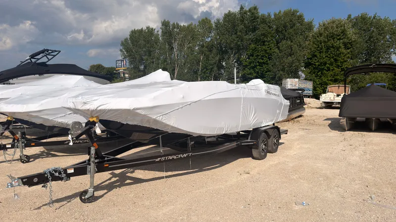 The Image of A 2027 Starcraft 211SVXOB boat, covered and parked on a trailer. - 0