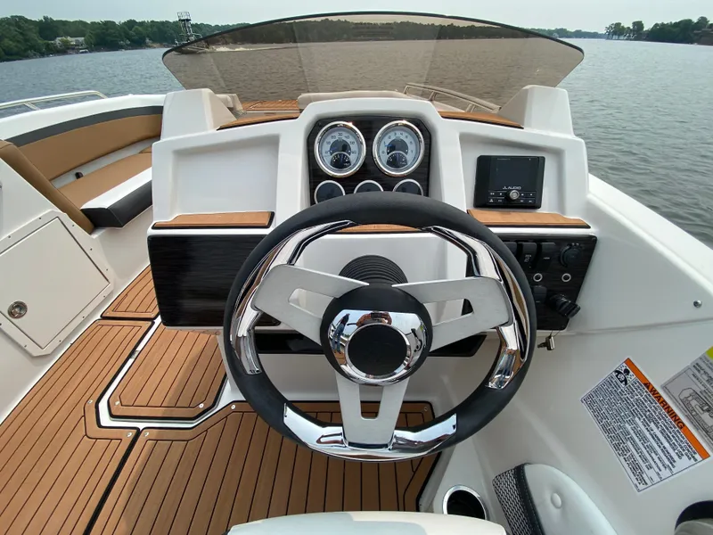 Slide: The Image of The image shows the helm of a 2027 Starcraft 211SVXOB boat with modern instruments. - 3