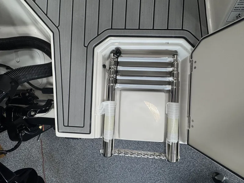 Slide: The Image of A built-in stainless steel swim ladder in a boat with a gray deck. - 5