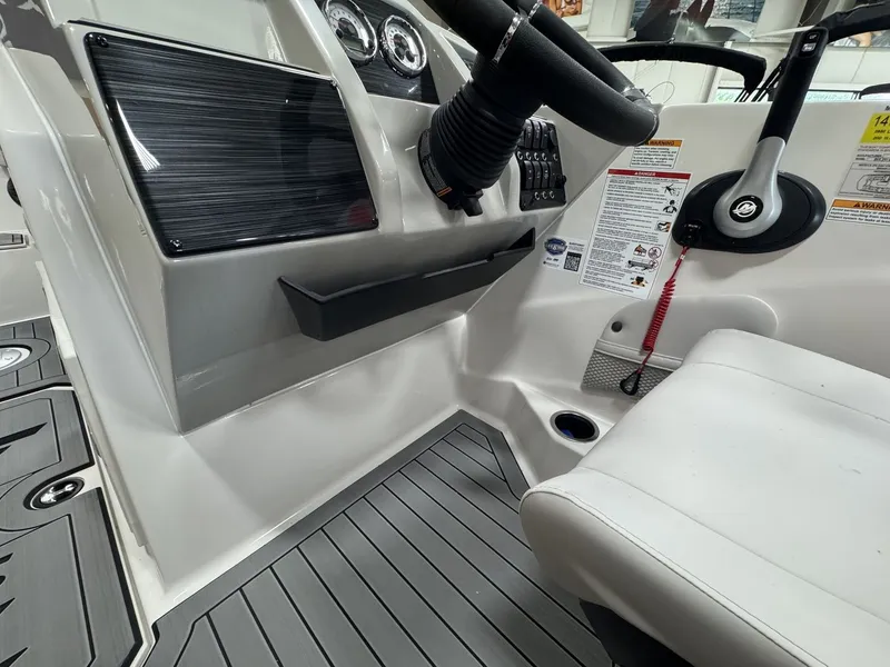 Slide: The Image of The image shows the cockpit of a 2027 Starcraft 211SVXOB with modern instruments and gray flooring. - 20