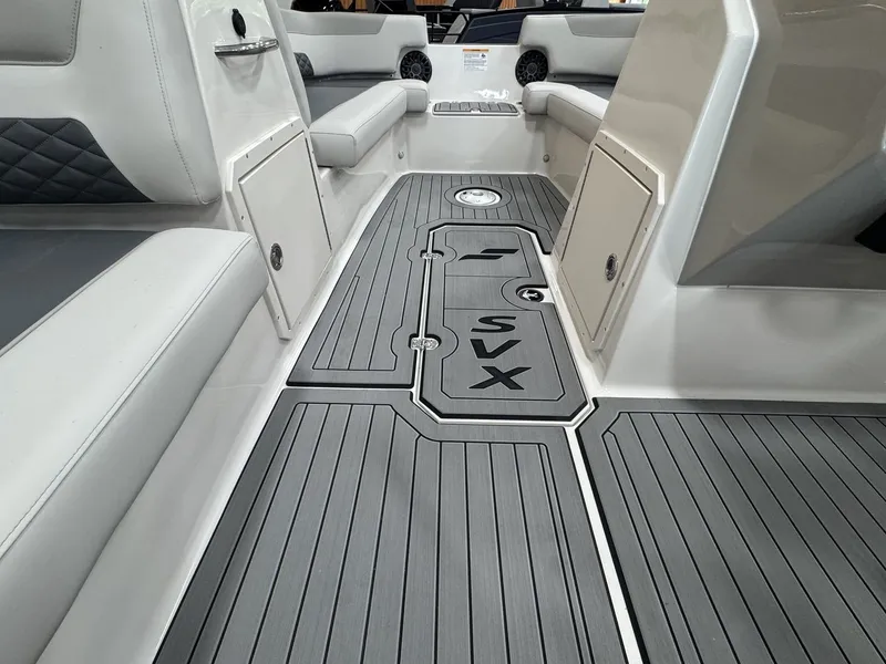 Slide: The Image of The image shows the interior of a 2027 Starcraft 211SVXOB boat with gray flooring. - 22