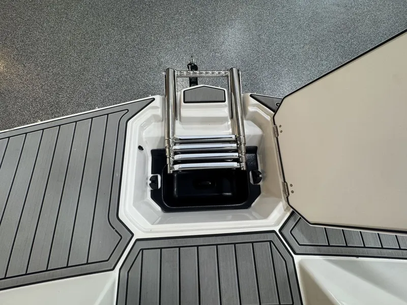 Slide: The Image of A swim ladder on a boat with a gray deck and storage compartment. - 36