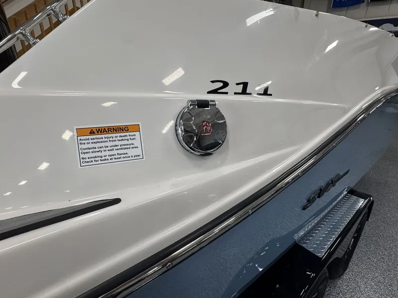 Slide: The Image of The image shows the stern of a Starcraft 211SVXOB boat with a warning and a fuel cap. - 39